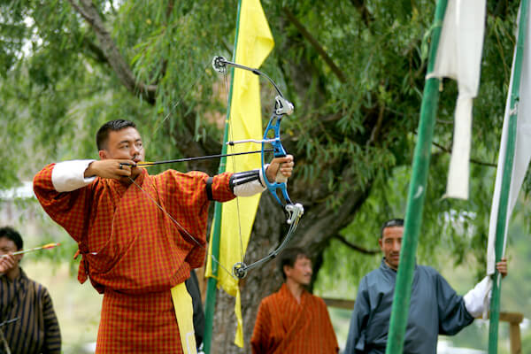 Bhutanese man in archery games - image by Oksana Perkins